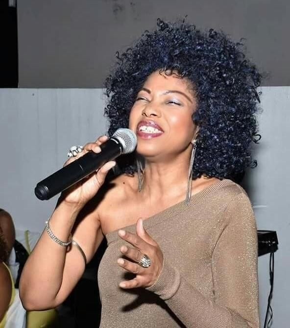 Stacia Hobdy performing live with a microphone