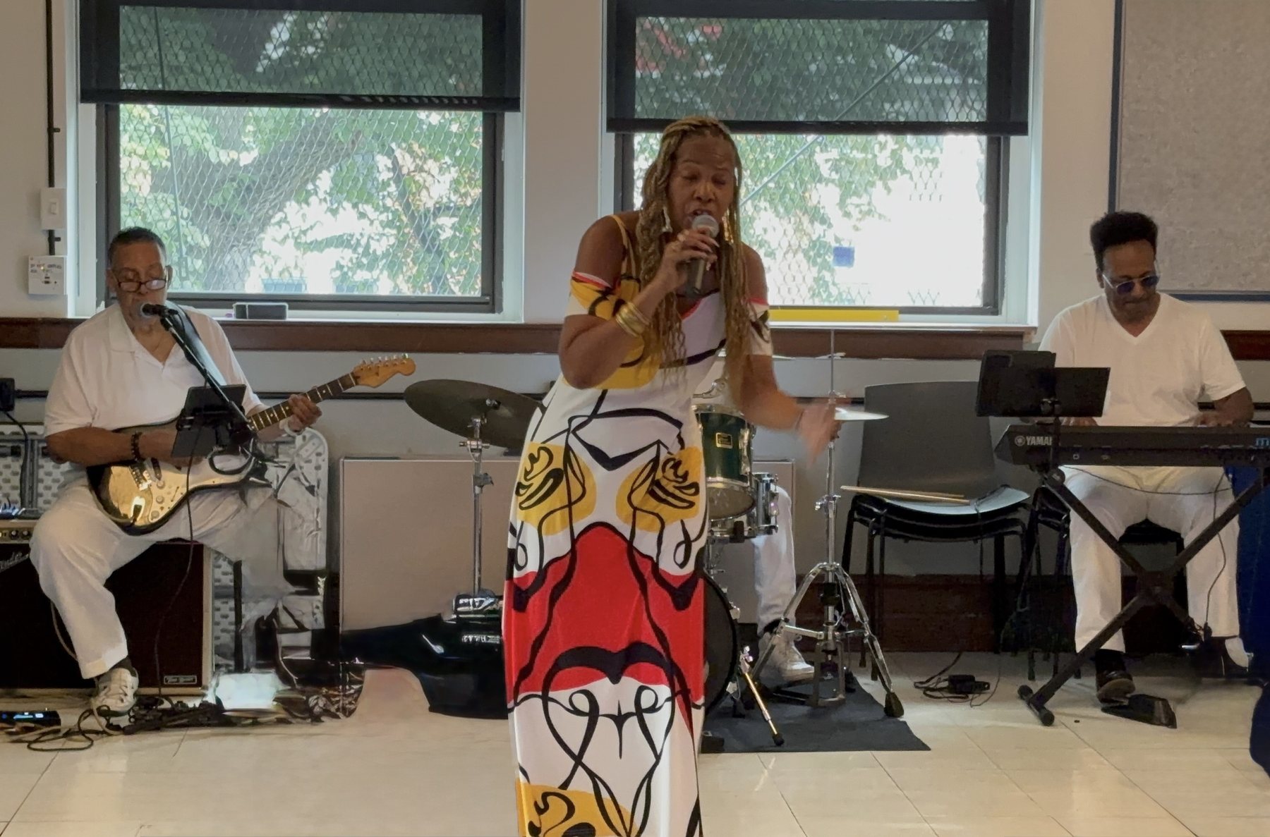 Stacia Hobdy performing under warm stage lighting during a soulful vocal set