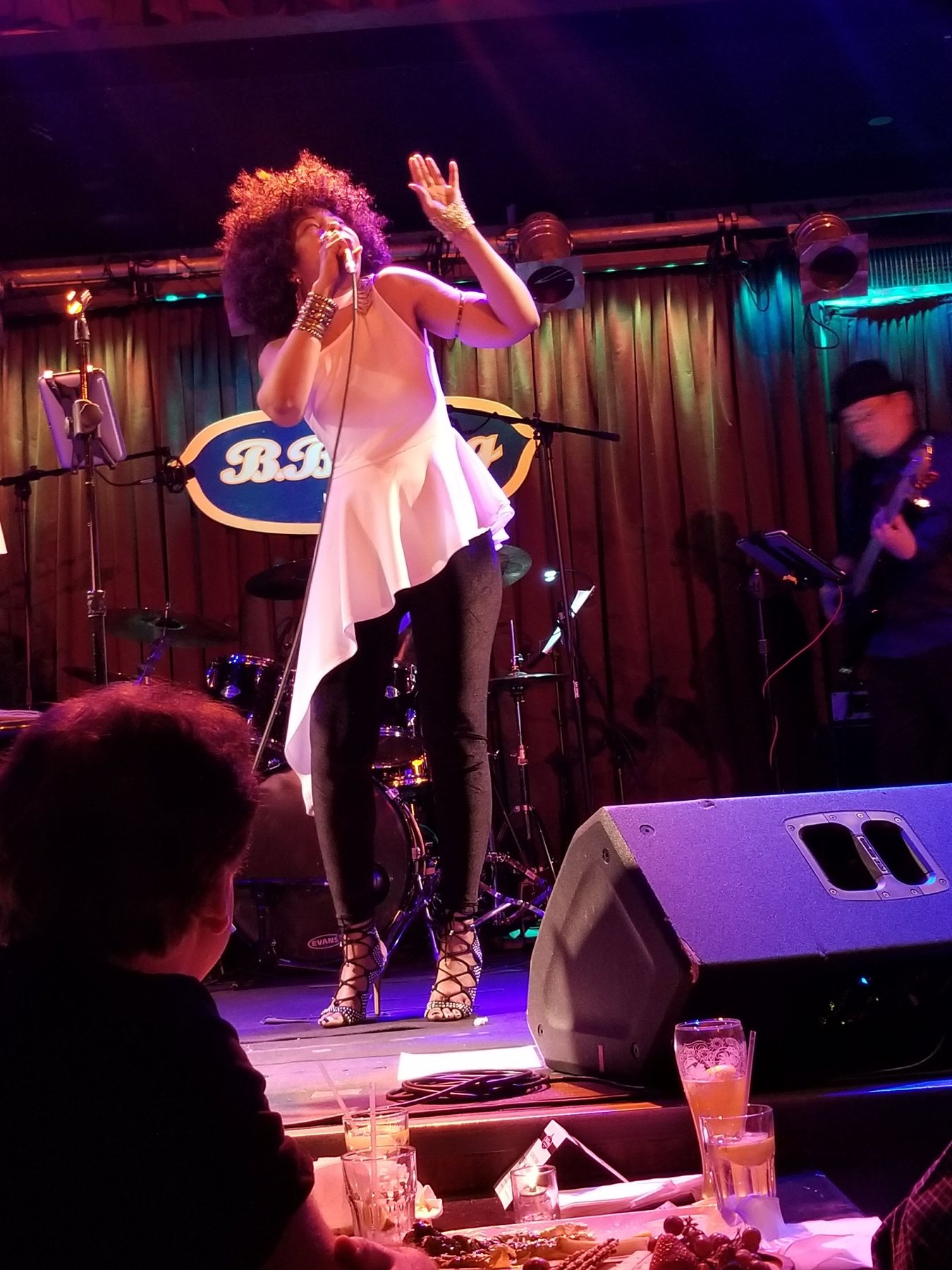 Stacia Hobdy performing live R&B and jazz vocals under stage lighting