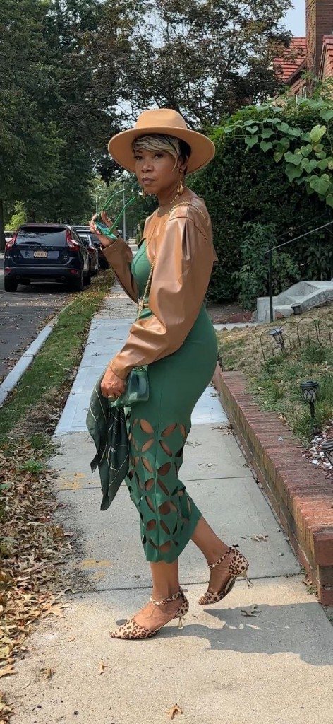 Stacia Hobdy in a green dress and tan hat