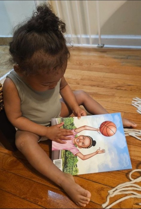 A young reader sitting with Mo's Big Shot