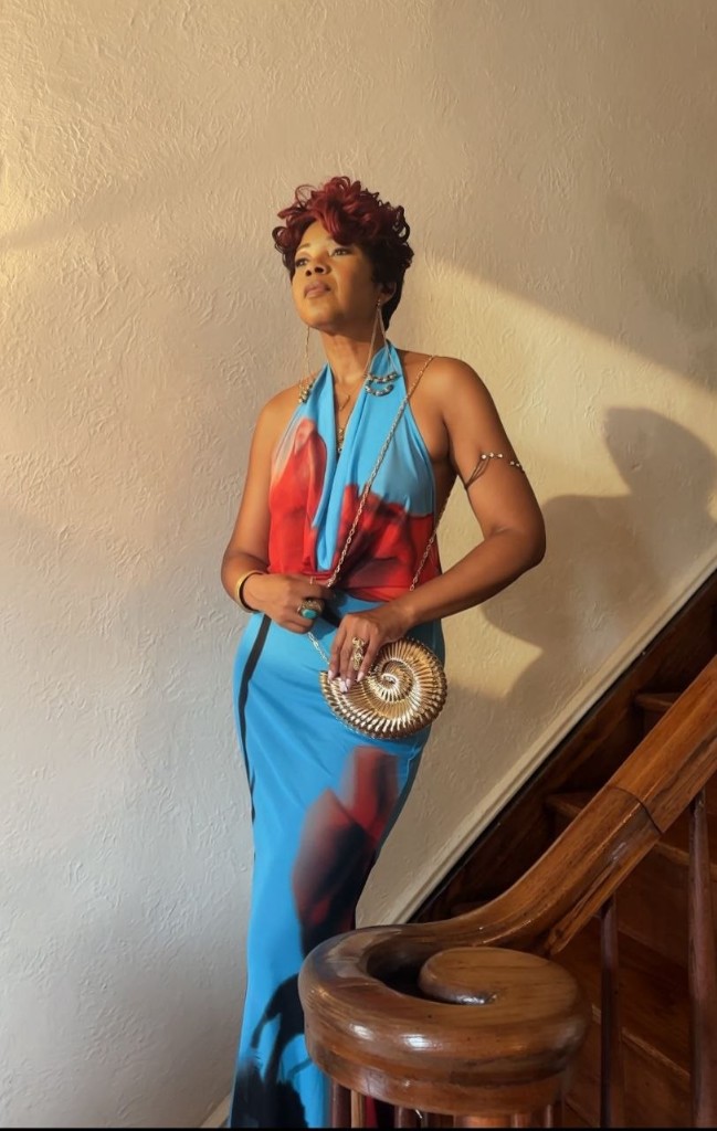 Stacia Hobdy in a blue floral halter gown