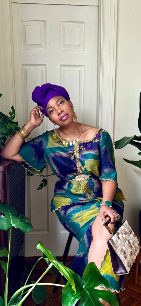 Stacia Hobdy in a purple headwrap and printed dress